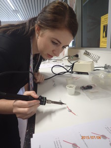 Ally soldering her microscope